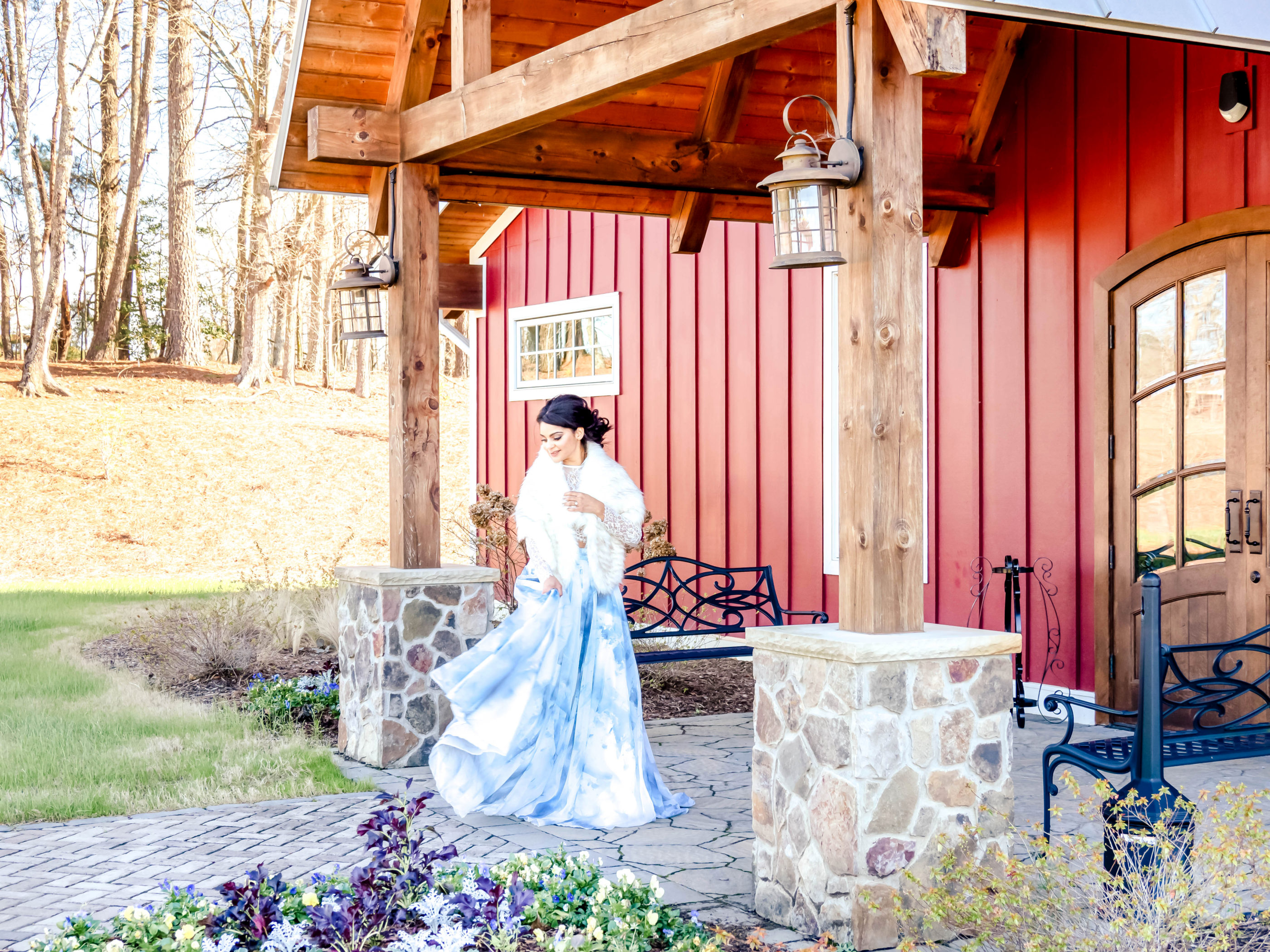 bride swishing dress while standing outside of the venue