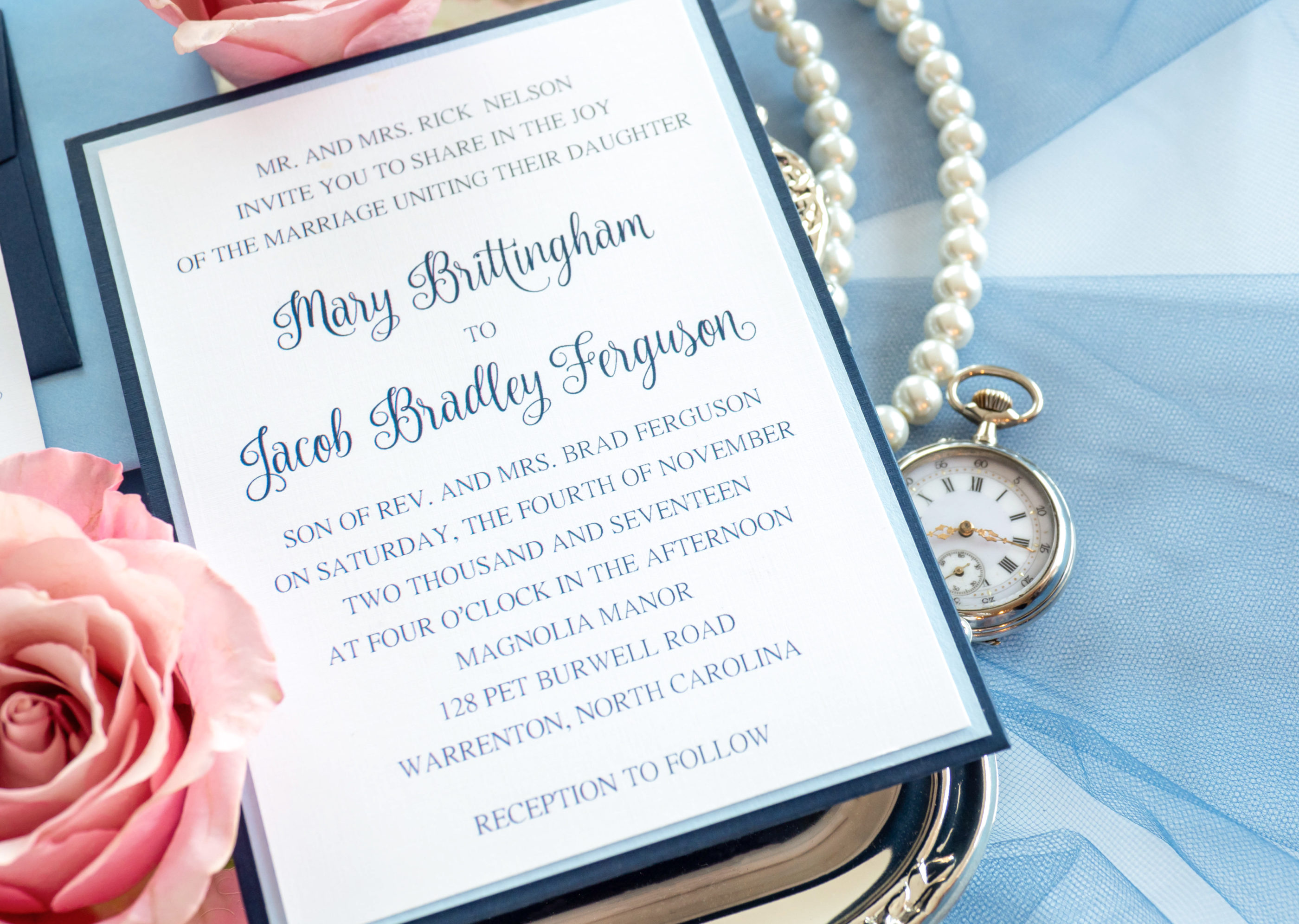 close photograph of navy and light blue wedding invitation suite