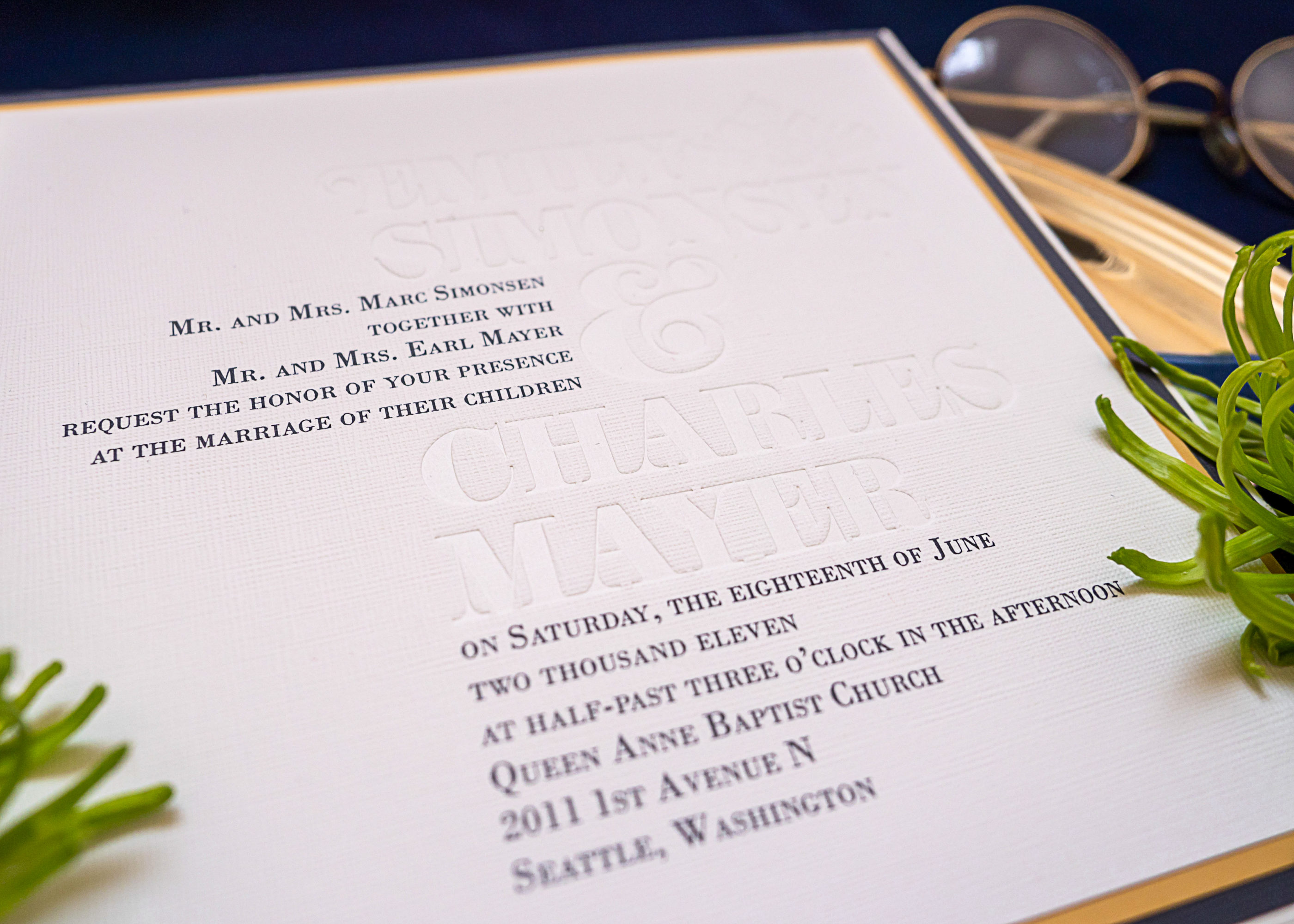 close up photo of debossed canvas paper invitation suite