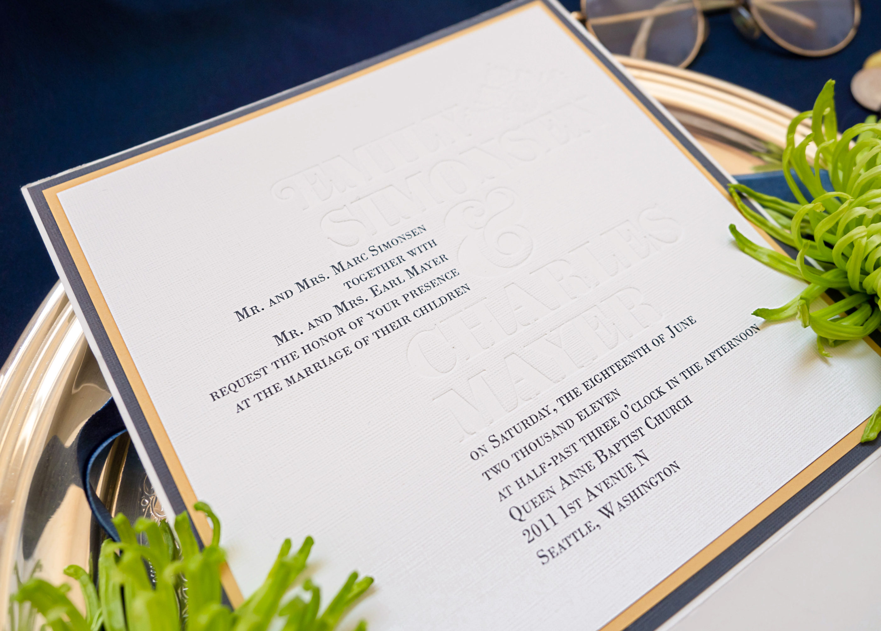 navy and gold invitation photographed up close to show debossing