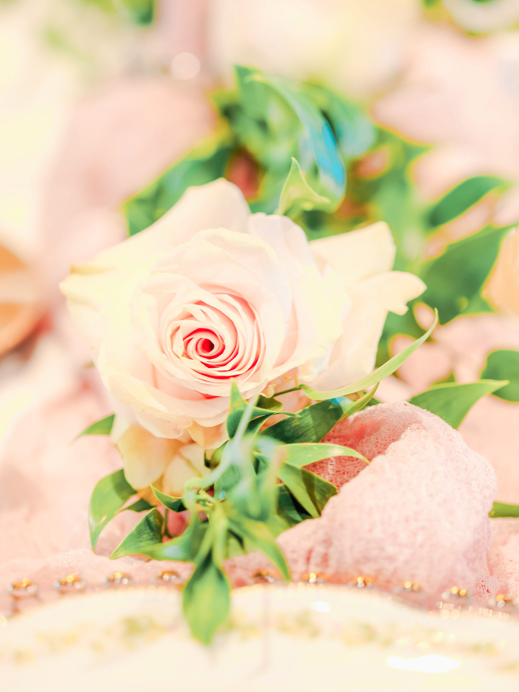 pink rose and greenery on reception table