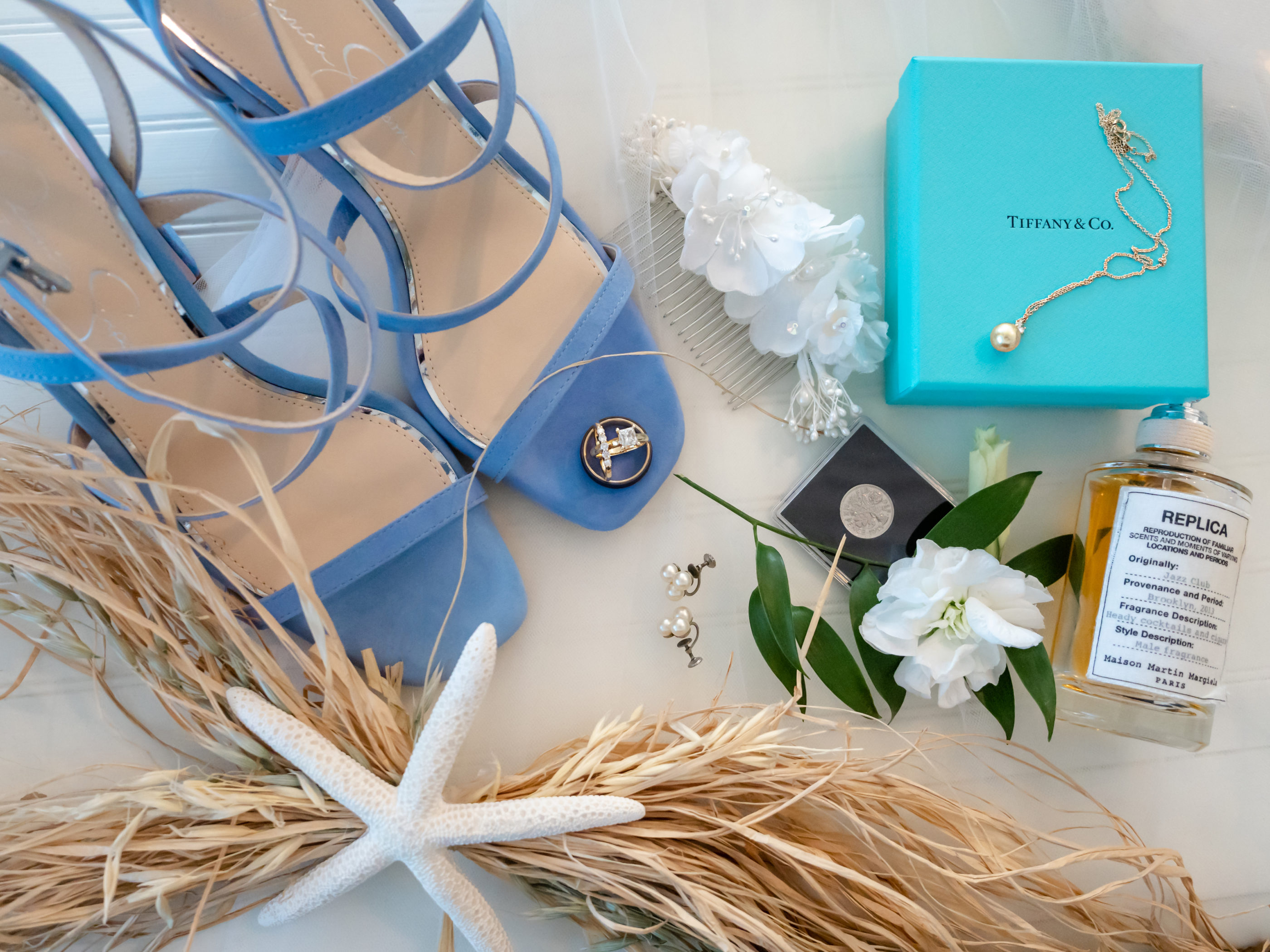 bride's details - blue shoes, rings, tiffany & co. necklace, perfume, sixpence, flowers, rafia, starfish, vintage pearl earrings, vintage white flower hair piece