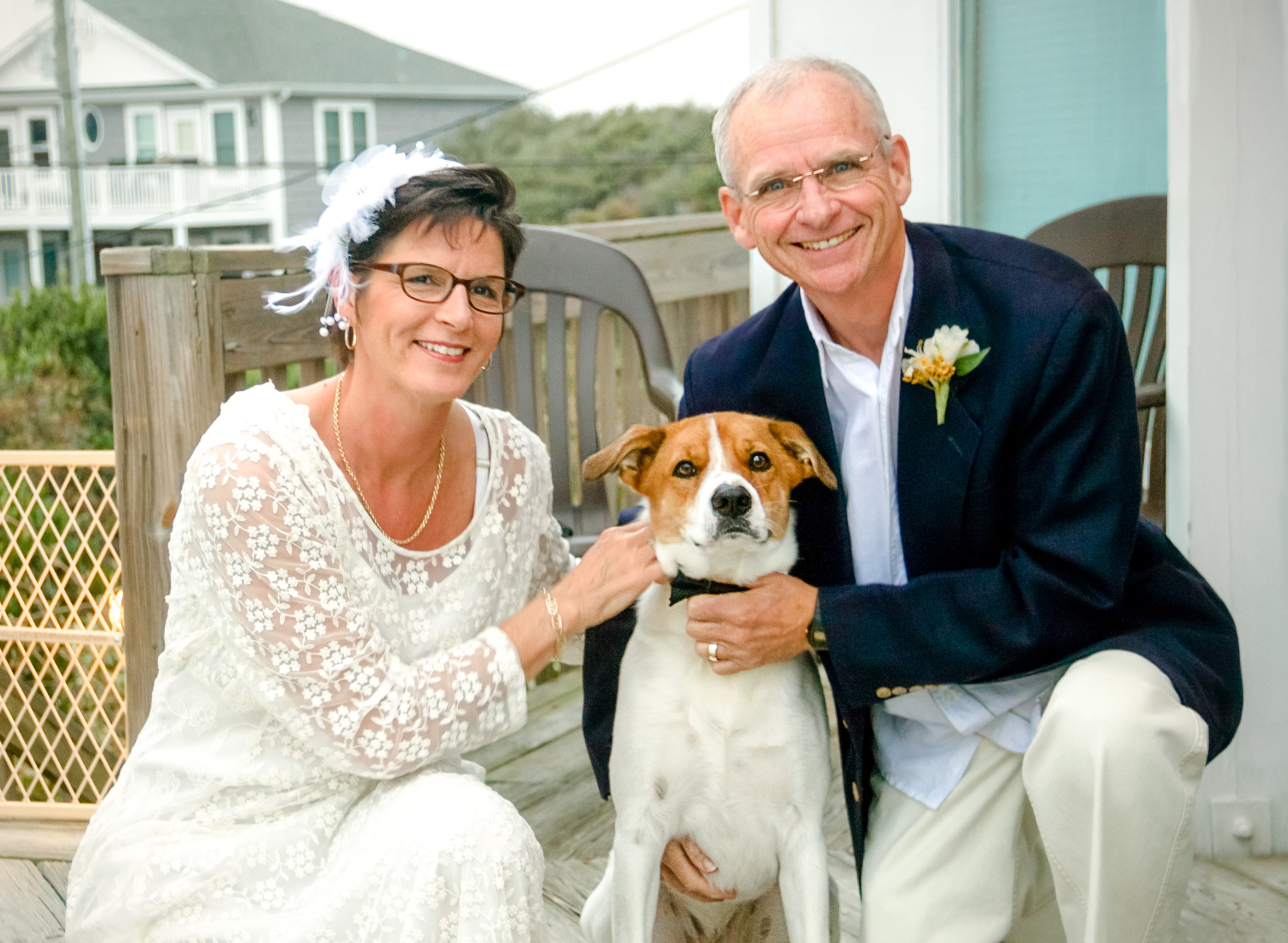 mature aged wedding couple and their dog who is the ring bearer posed for photo