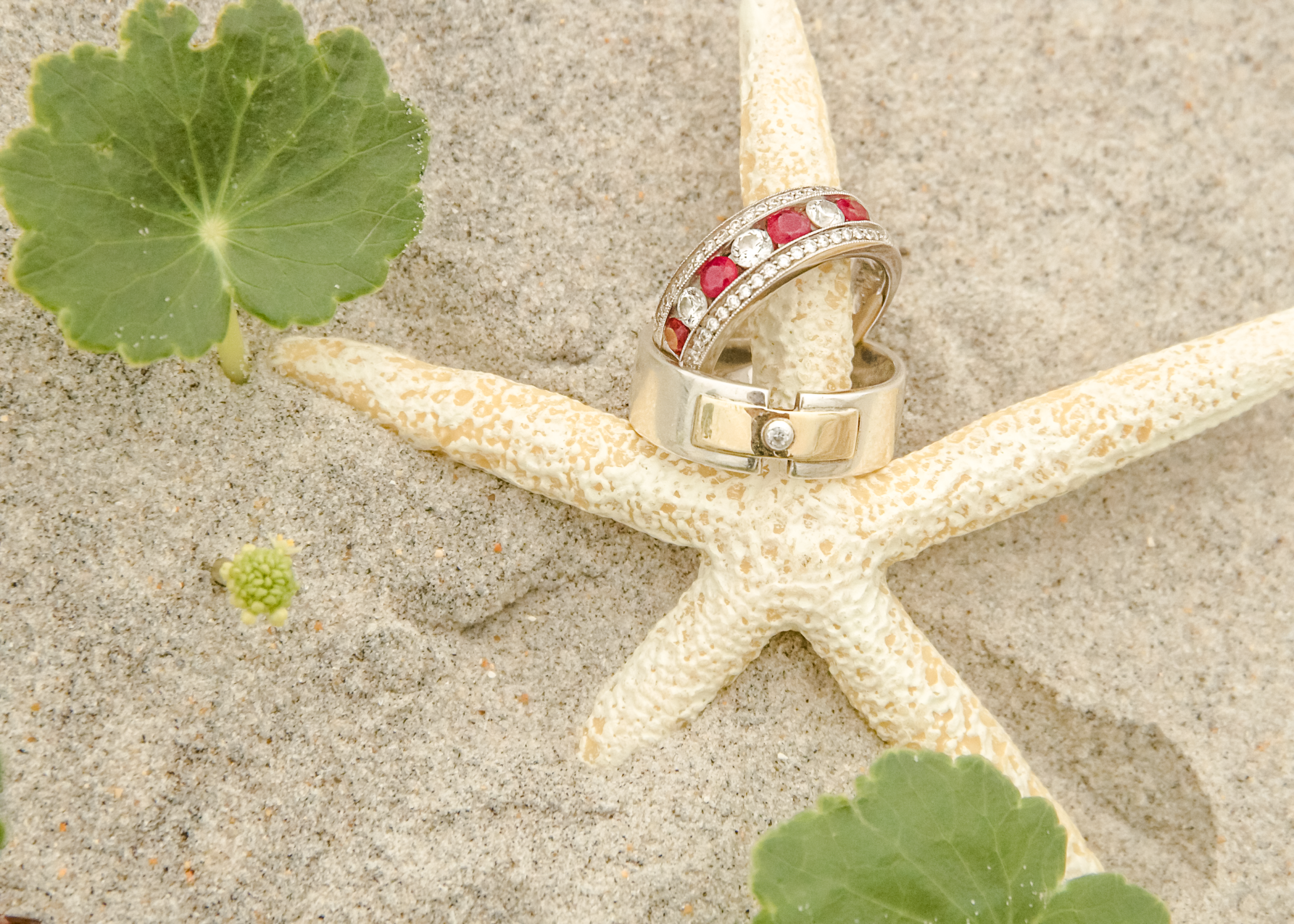 wedding bands on starfish in the sand