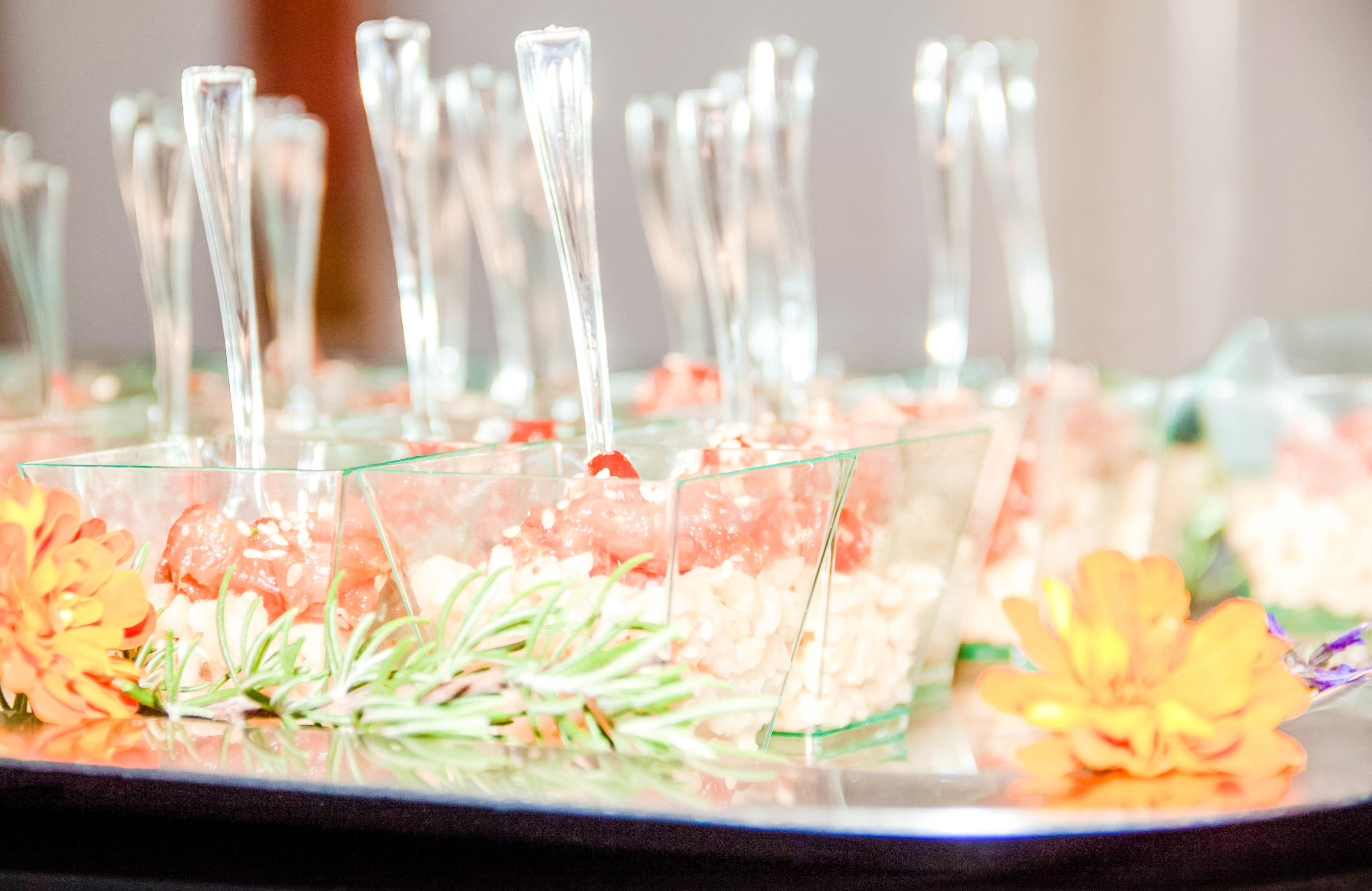 tray of little square containers with rice and shrimp at reception